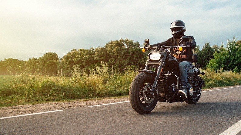 Harley Davidson Fat Bob 114 2020 motorcycle driver riding alone on a freeway. Kharkiv, Ukraine-15 July 2021.