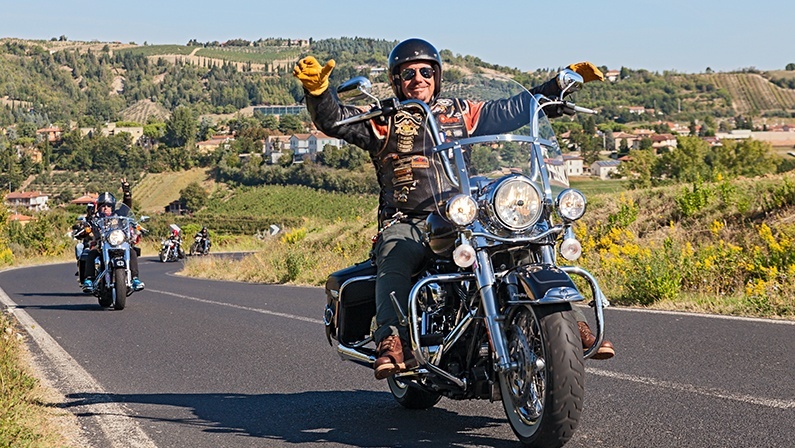 RIOLO TERME, ITALY - SEPTEMBER 22: happy biker leads a group of bikers riding Harley Davidson in motorcycle rally "Sangiovese tour" by Ravenna Chapter on September 22, 2013 in Riolo Terme (RA) Italy